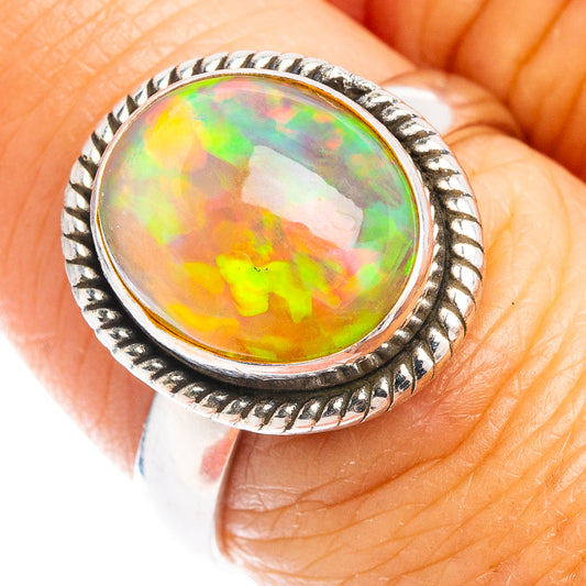 Sterling silver opal ring with oval rainbow fire stone and rope-textured bezel