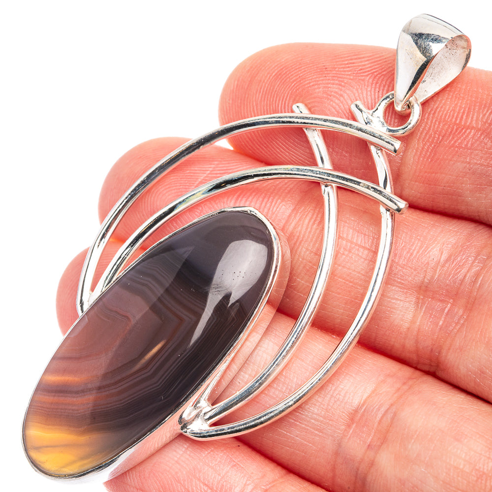 Sterling silver agate pendant with oval dark brown and orange striped cabochon, loop bail