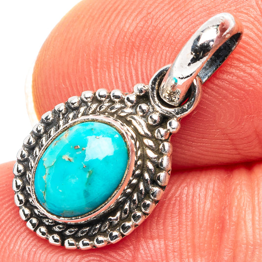 Turquoise oval pendant in detailed .925 sterling silver setting with loop bail