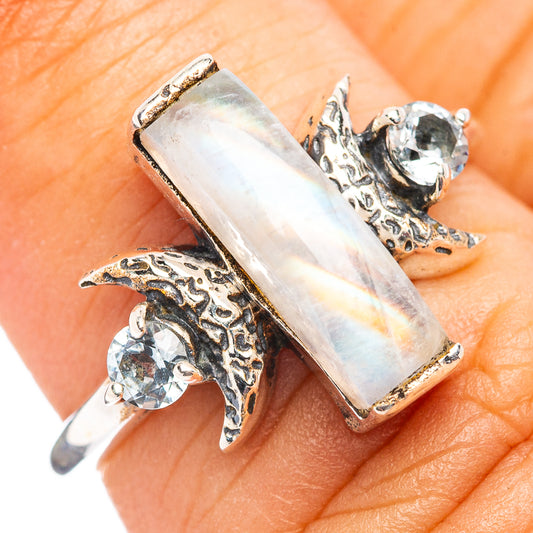 Sterling silver ring with rectangular iridescent gemstone and blue stone accents