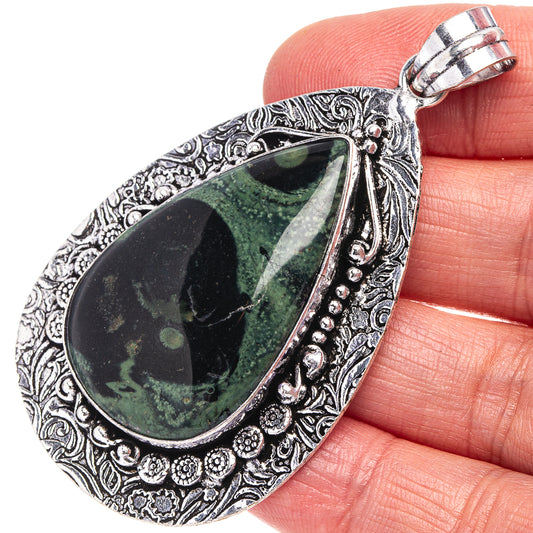 German silver teardrop jasper pendant with ornate filigree and green stone bezel