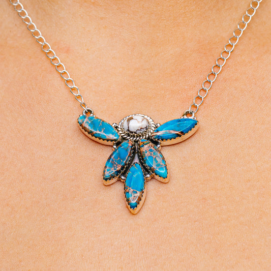 Blue gemstone flower pendant necklace with silver chain and teardrop accents