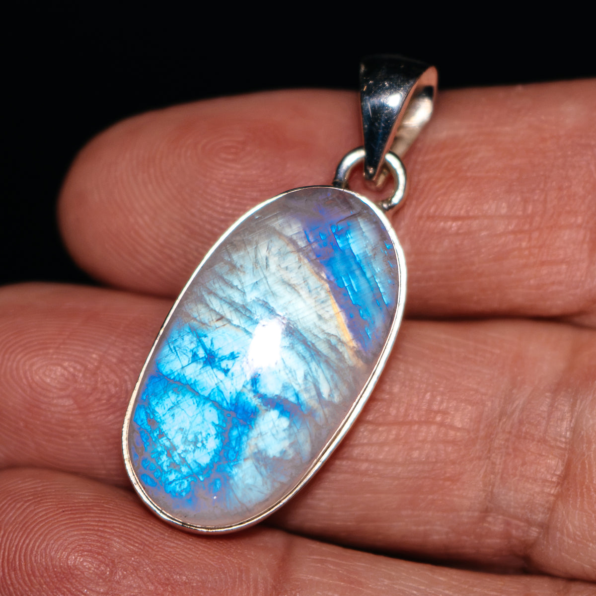 Oval rainbow moonstone pendant in .925 sterling silver with silver bail, blue iridescence