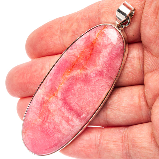 Pink rhodochrosite teardrop pendant with .925 sterling silver bail, close-up