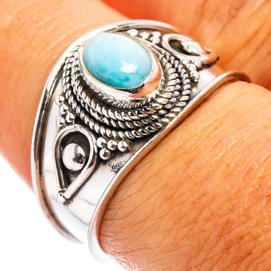 Sterling silver cocktail ring with blue oval gemstone bezel and ornate rope details