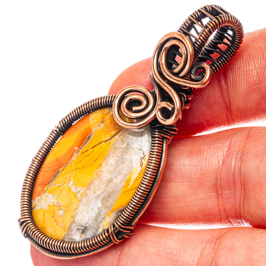 Oxidized copper wire wrap pendant with spiral bezel over yellow and white stone