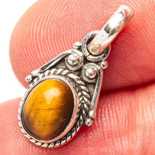 Tiger's eye pendant with ornate .925 sterling silver filigree bezel and bail
