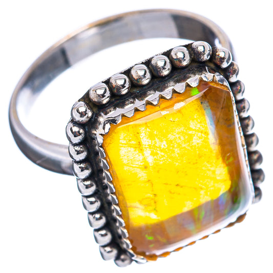 Sterling silver ring with yellow oval opal and beaded edge, angled side view