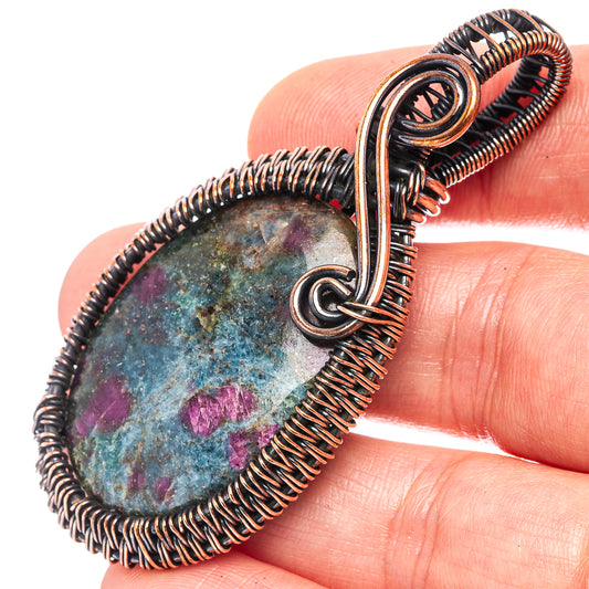 Oxidized copper wire-wrap pendant with blue-purple stone, teardrop loop bail
