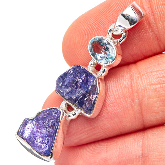 Sterling silver pendant with blue topaz bezel and three purple rough tanzanite stones