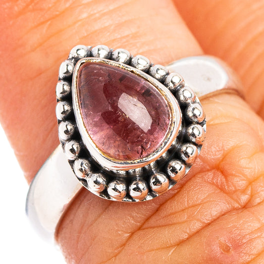Sterling silver ring with oval pink tourmaline cabochon and beaded halo setting
