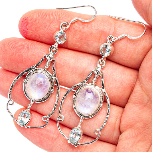 Sterling silver dangle earrings with oval rainbow moonstone and blue topaz accents