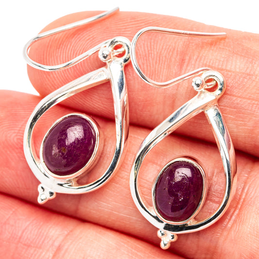 Sterling silver teardrop ruby earrings with dangling hooks, deep purple stones