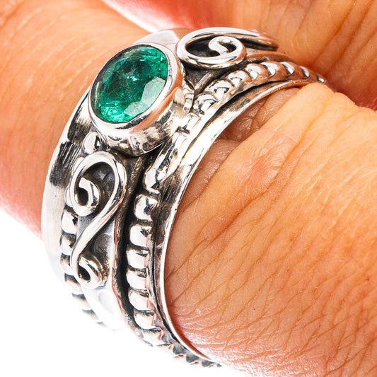 Sterling silver ring with round green emerald-style gemstone and ornate side engravings
