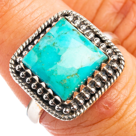 Turquoise square cabochon sterling silver ring, close-up on finger