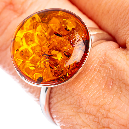 Round amber cabochon ring in .925 sterling silver, translucent honey-gold center.
