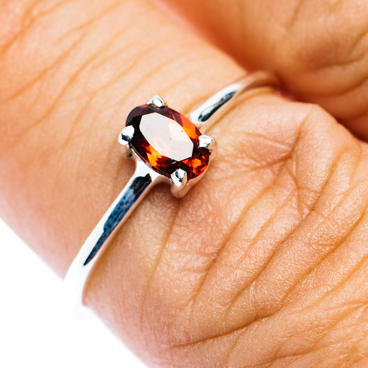 Sterling silver stackable ring with oval dark red garnet, prong setting