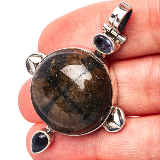 Sterling silver pendant close-up with round brown stone and three iolite accents