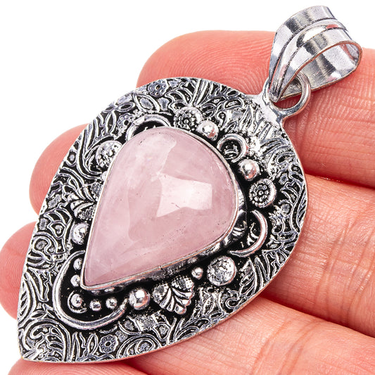 German silver rose quartz teardrop pendant with ornate filigree border and bail