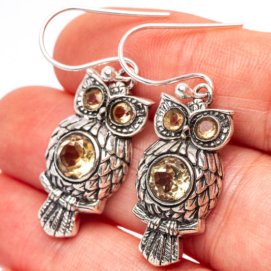 Sterling silver owl drop earrings with yellow citrine glass stones, close-up pair