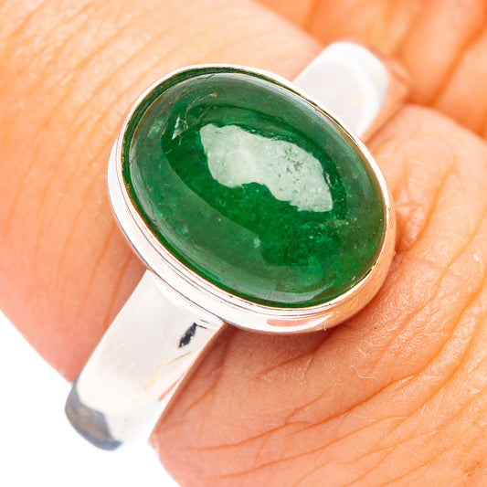 Oval green gemstone sterling silver ring, close-up of bezel setting