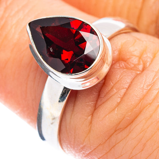 Sterling silver ring with faceted dark red garnet teardrop centerpiece