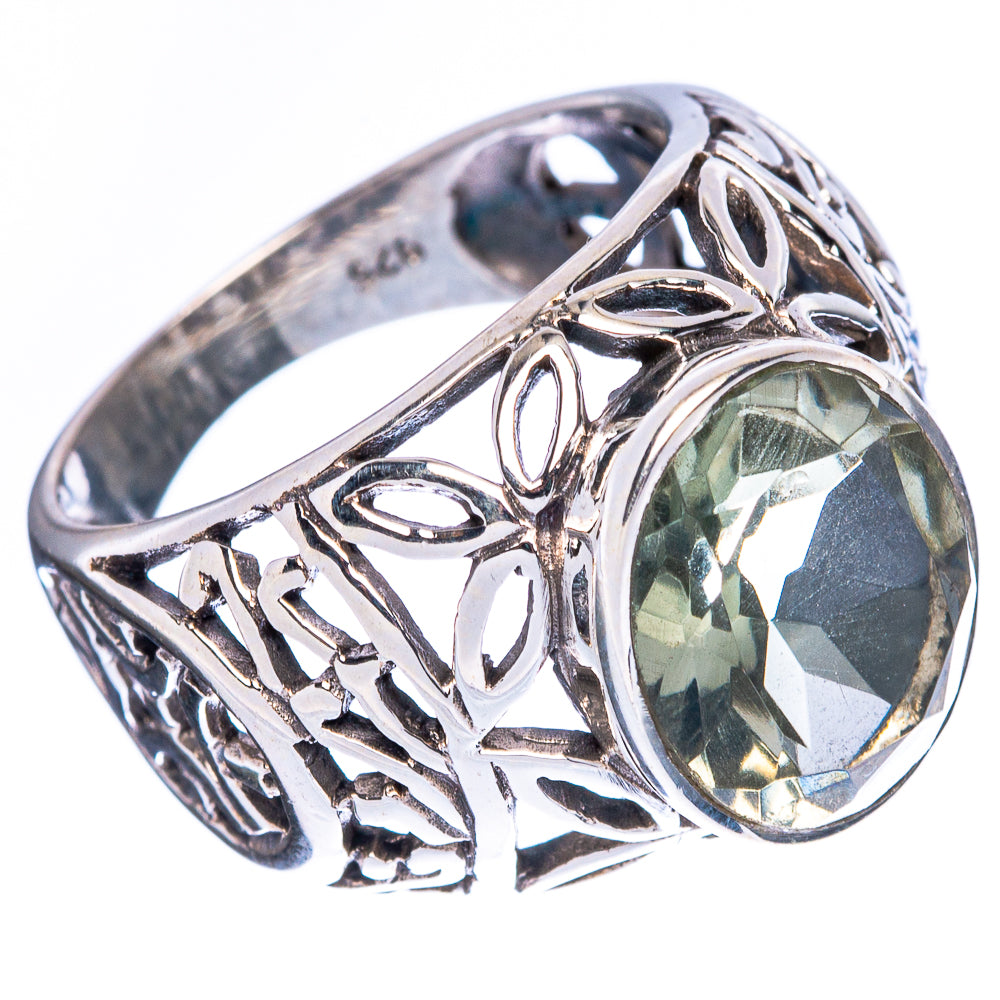 Sterling silver ring with oval faceted green gemstone and detailed openwork side design
