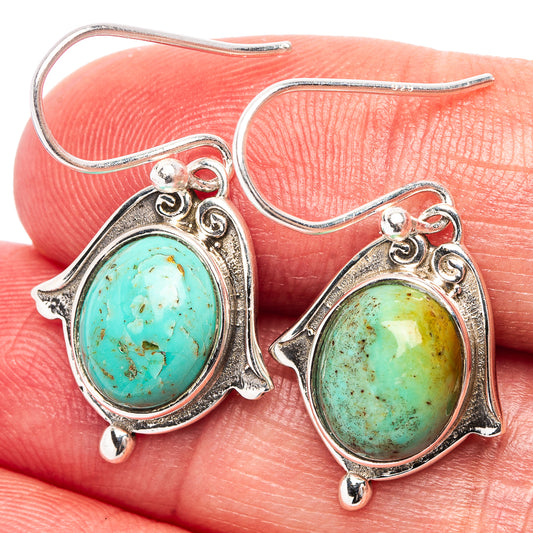 Turquoise oval cabochon dangle earrings with .925 sterling silver hooks and ornate bezel