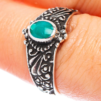 Turquoise gemstone ring in sterling silver with ornate carved band and oval green center stone