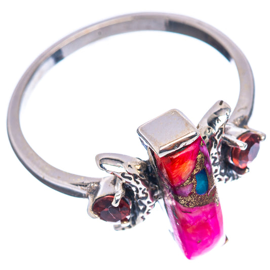 Sterling silver ring with faceted magenta rectangular stone and red accents
