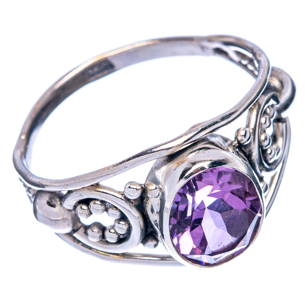 Sterling silver ring with oval faceted amethyst and ornate filigree scroll setting