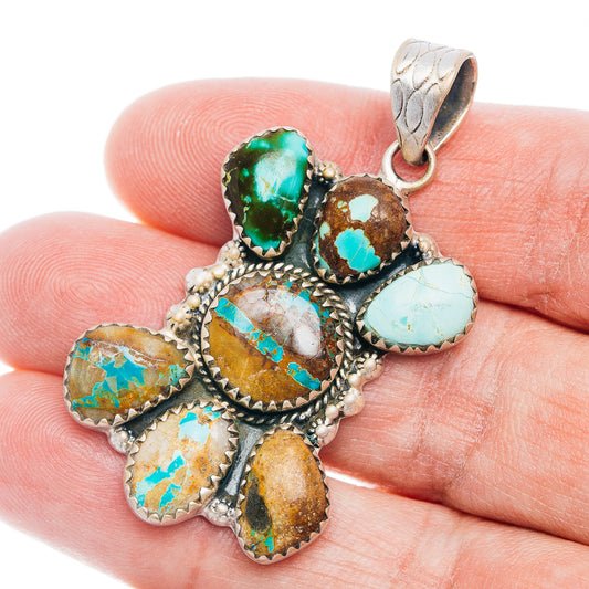 Multistone opal-like turquoise pendant with detailed silver bezels in hand