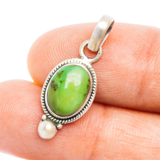 Oval green gemstone pendant in silver bezel with scalloped edge and bail