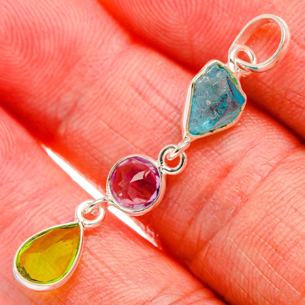Sterling silver dainty pendant with blue, purple, and green gemstones in teardrop settings