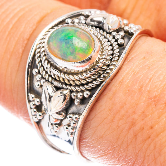 Sterling silver opal ring with oval green Ethiopian opal and ornate rope bezel
