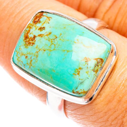 Turquoise rectangle cabochon sterling silver ring on finger, bordered frame