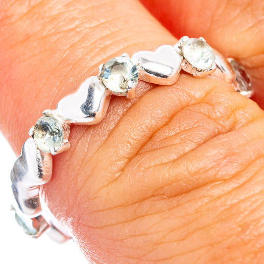 Sterling silver dainty ring with prong-set blue topaz stones, polished band