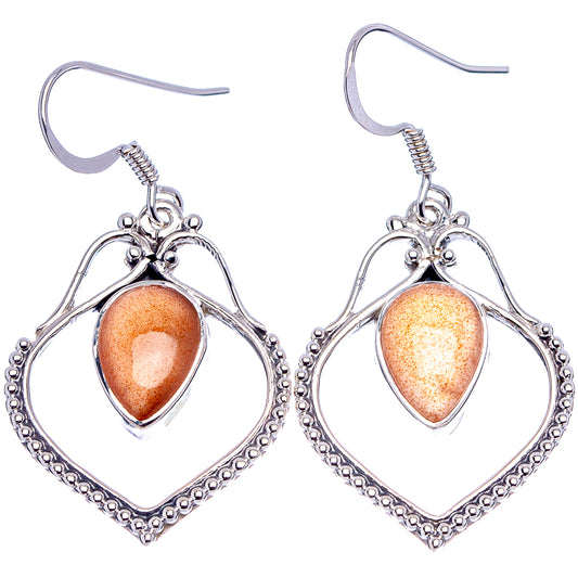 Peach moonstone earrings with silver teardrop/heart surrounds, faceted oval cabochons and hooks
