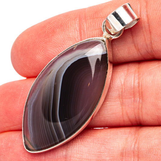 Sterling silver marquise pendant with dark banded Botswana agate cabochon, top bail.