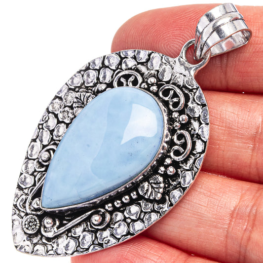 German silver opal pendant with light blue oval stone and ornate halo setting