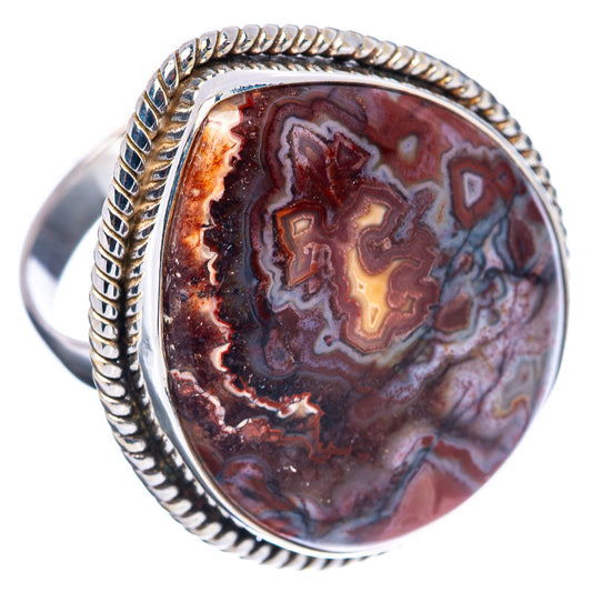 Sterling silver oval ring with rope border bezel and red, blue, tan crazy lace agate