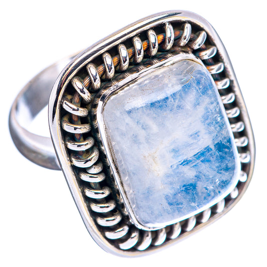 Sterling silver ring with oval-cut blue moonstone cabochon and linked halo band
