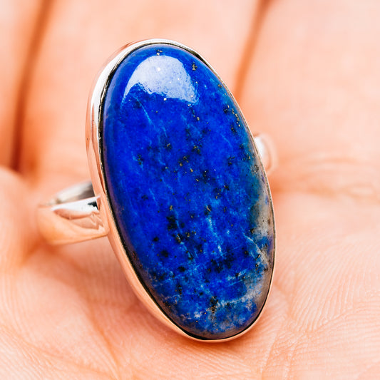 Sterling silver ring with oval blue cabochon gemstone in bezel, side view