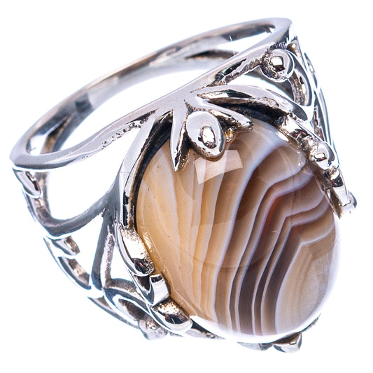 Sterling silver agate ring with openwork band and oval striped cabochon, high polish