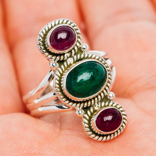 Sterling silver gemstone ring with green oval center and red oval side stones, ornate halos