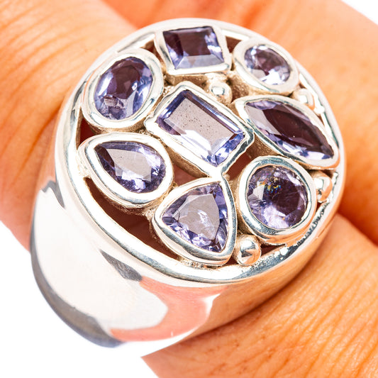 Sterling silver ring with faceted purple-blue gemstones in a bezel cluster setting