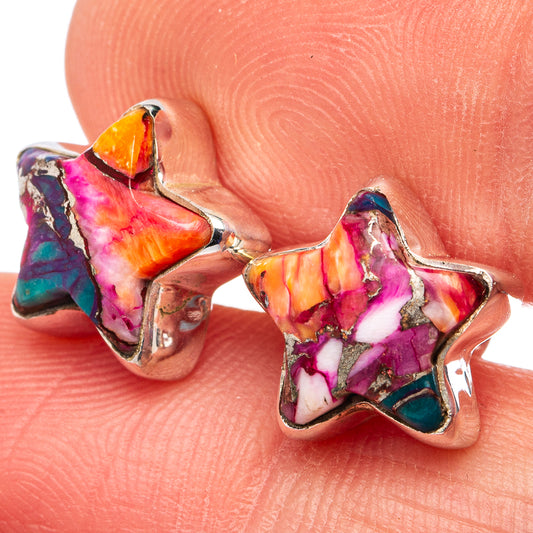 Close-up of multicolor star earrings on silver posts, showing bright purple, orange, teal.
