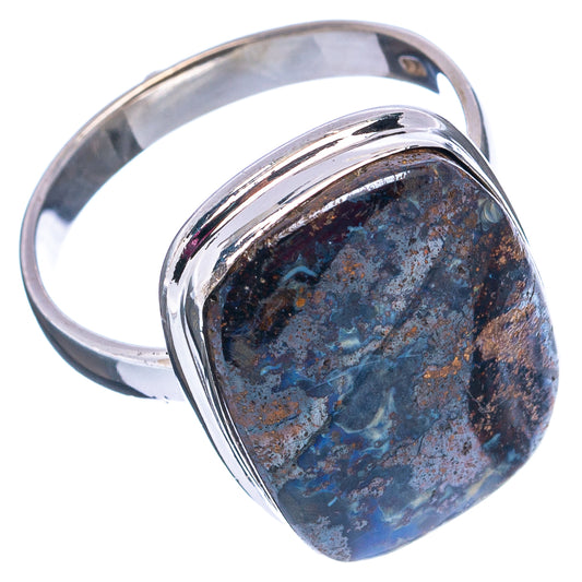 Sterling silver ring with oval boulder opal cabochon in raised bezel, blue-black