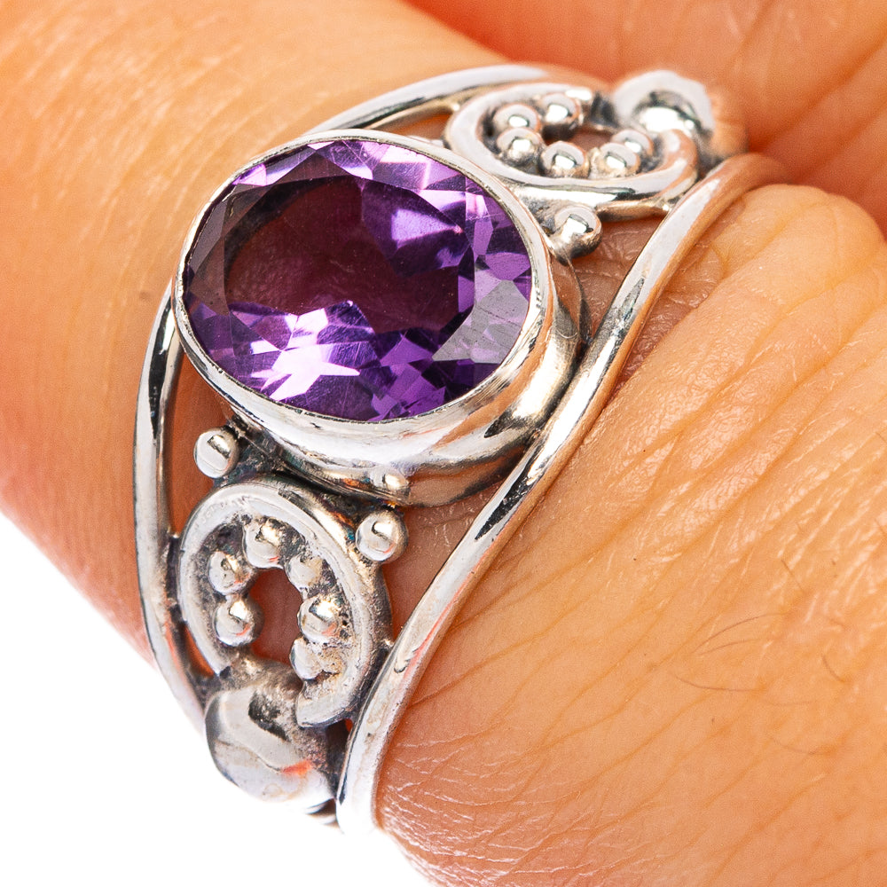 Sterling silver amethyst ring with round faceted purple gemstone and decorative bezel