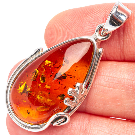Teardrop Baltic amber pendant in .925 sterling silver with silver bail and loop